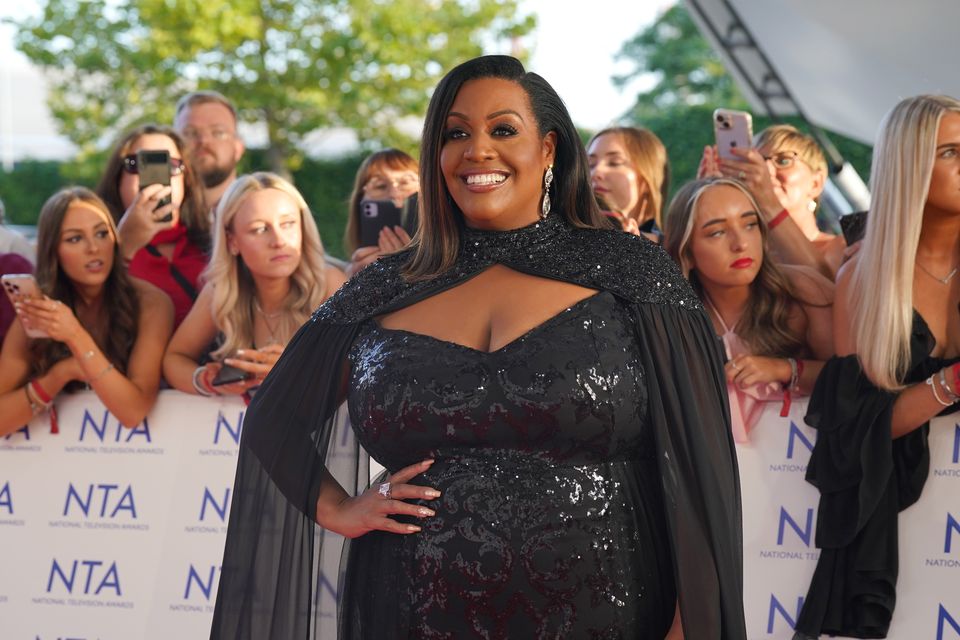 Alison Hammond is posing for photographers.