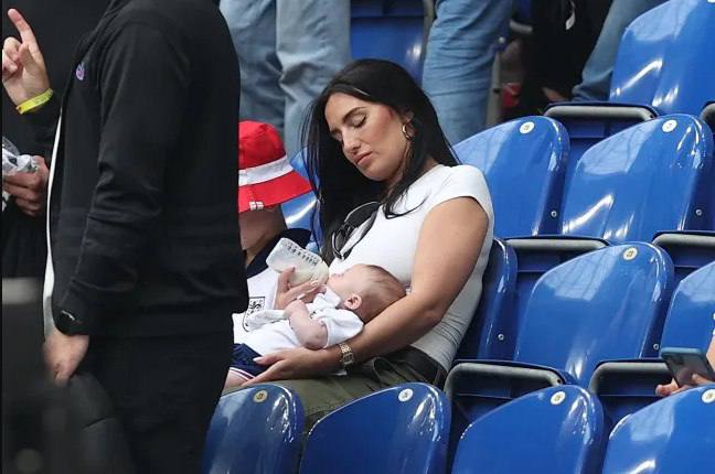 Annie Kilner feeds her newborn baby boy during Kyle's football match